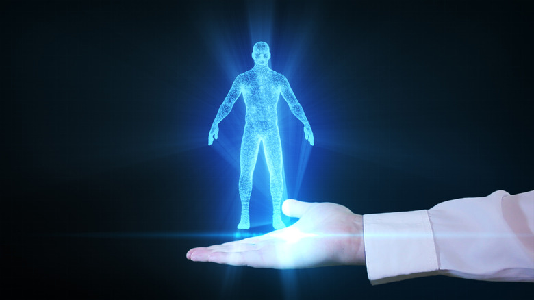 Home businessman is holding a human hologram in his hand